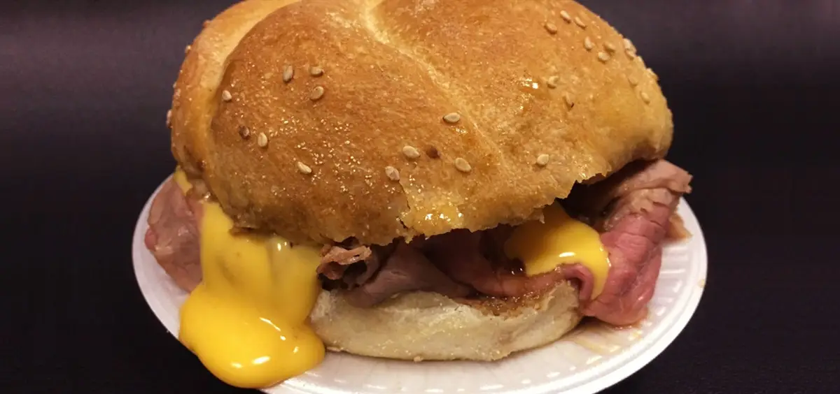 a sandwich with cheese and meat on a plate